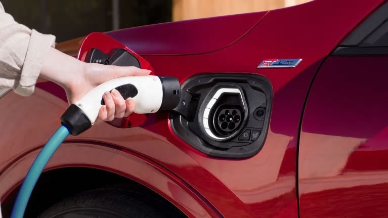 Red All-New Ford Kuga PHEV charging at home